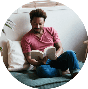 A man relaxing and reading a book.